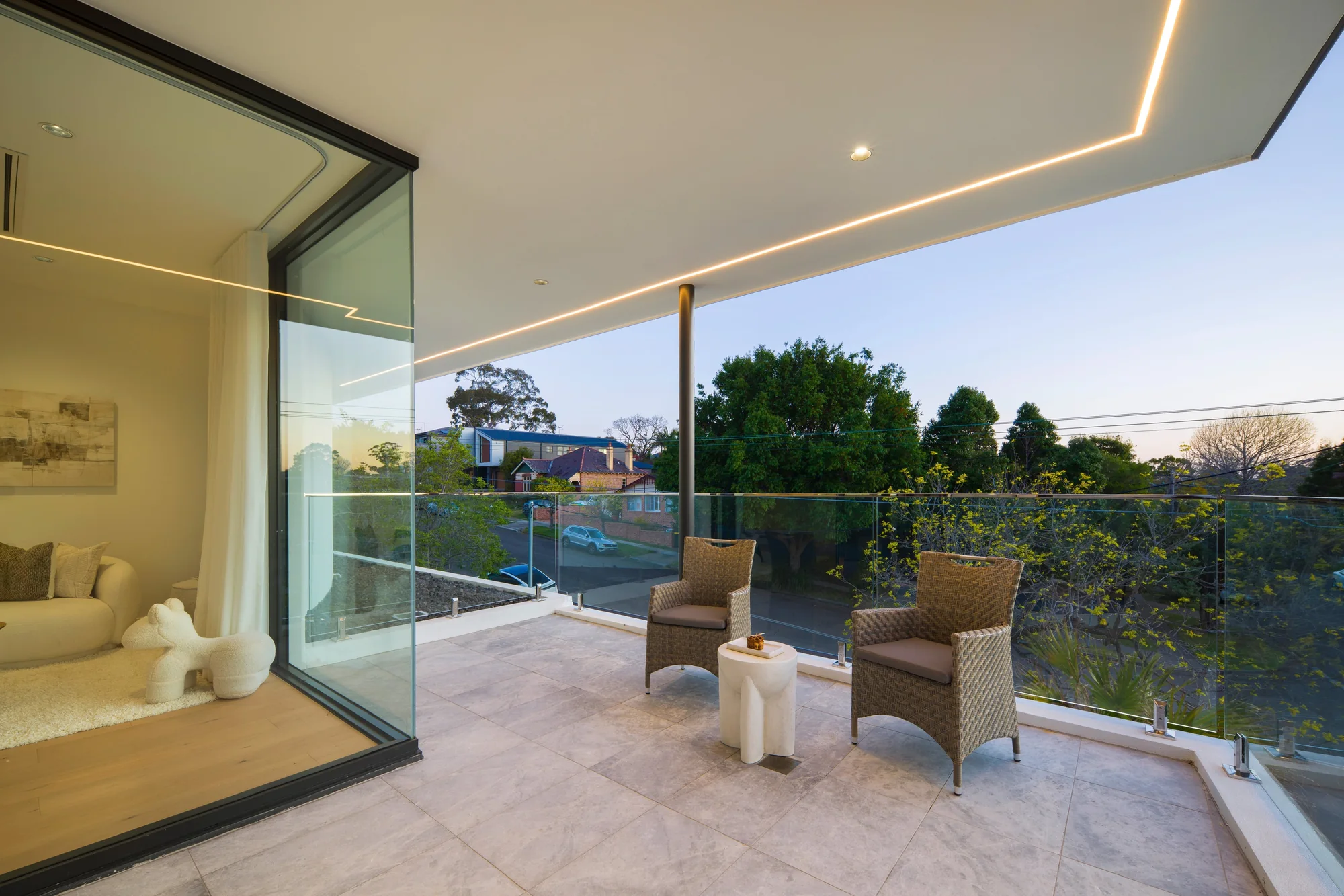 Covered terrace with glass balustrades and outdoor seating